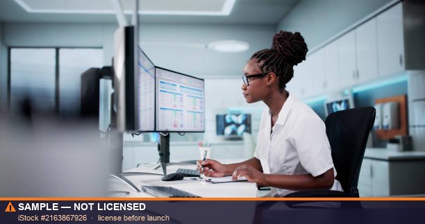 Medical billing specialist entering claims on a laptop beside a stethoscope
